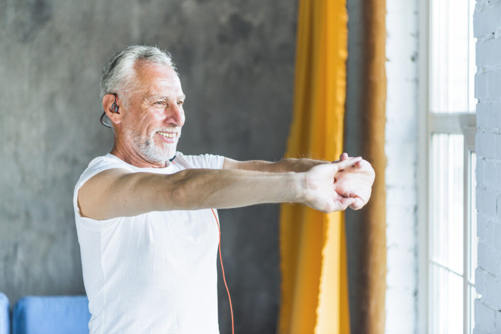 happy-senior-man-stretching-his-hand-while-doing-exercise